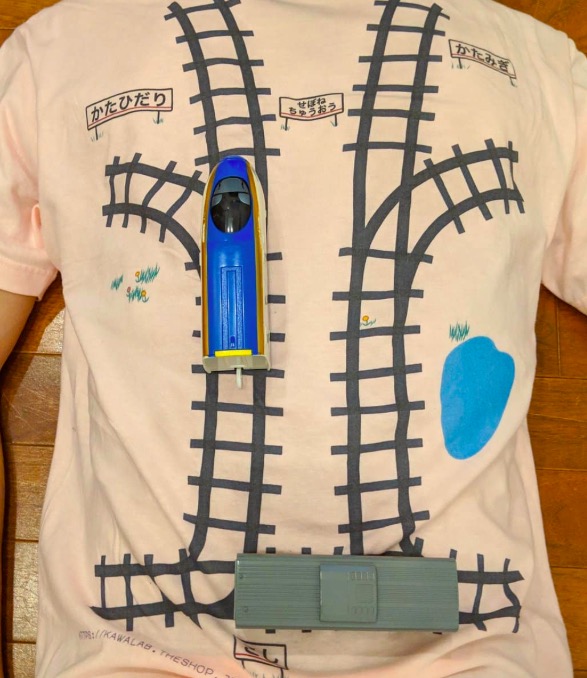 father designs a t-shirt with train track for son to do back massage