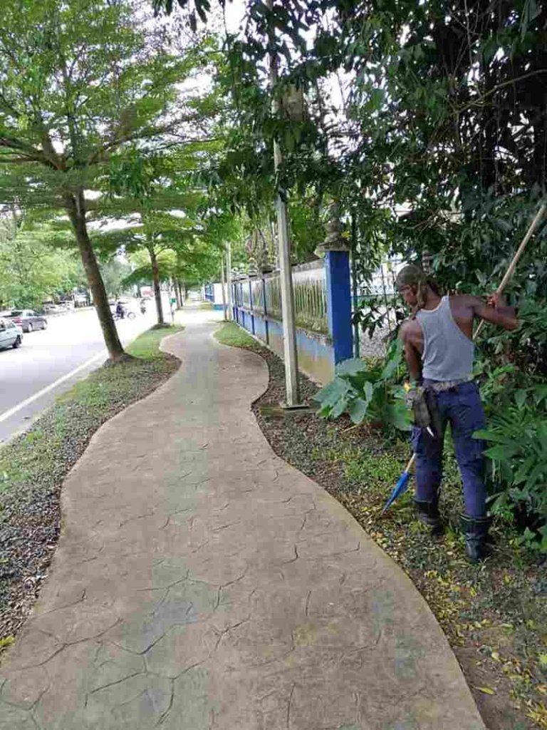 Man Clean Street in Malaysia for Free