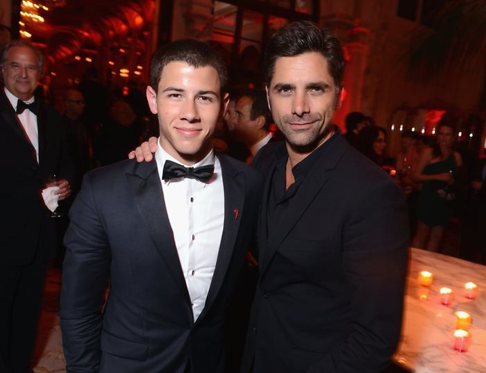 Nick Jonas And John Stamos Are Trolling Eachother