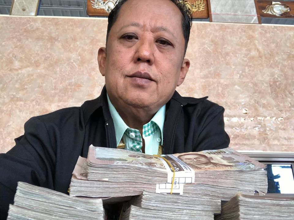 Thai millionaire farmer Arnon Rodthong giving money to marry his daughter