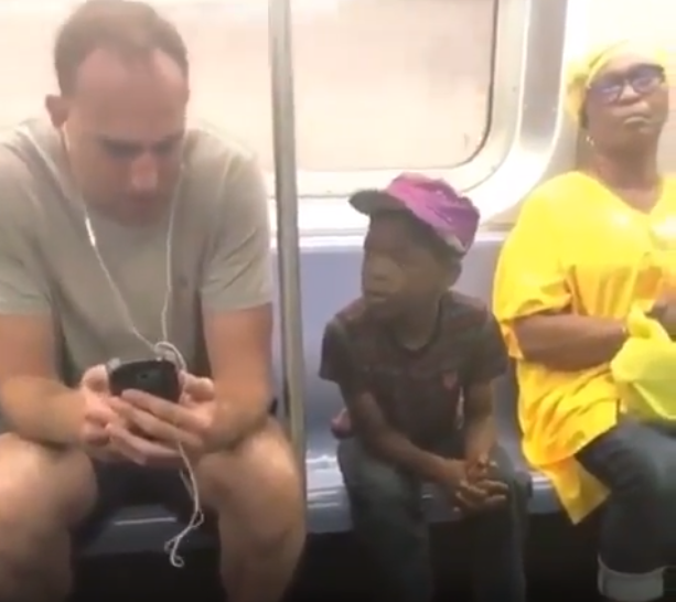 Man gives his phone to a boy who was staring at it