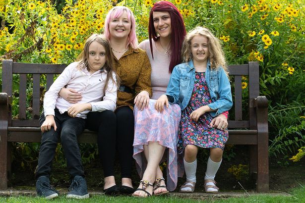 The happy family with a same gender couple after husband transforms into a woman