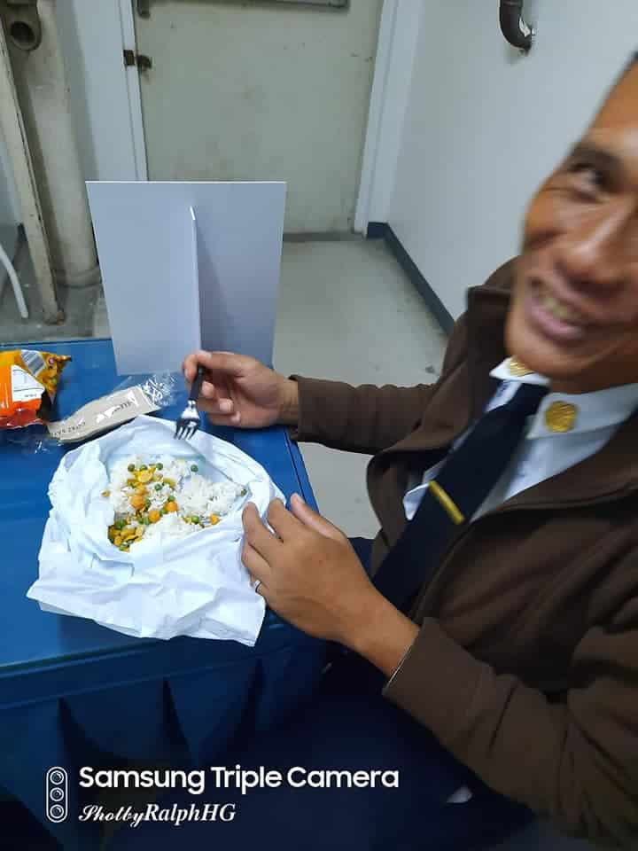 guard eating junk food with rice to send money to family