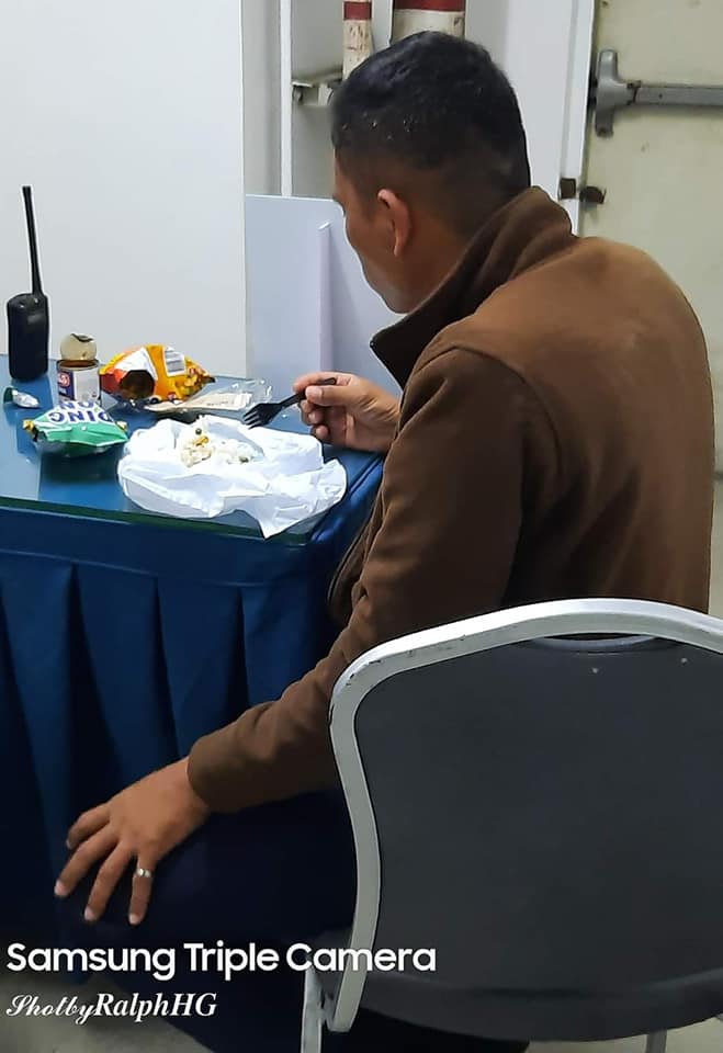 guard eating junk food with rice to send money to family