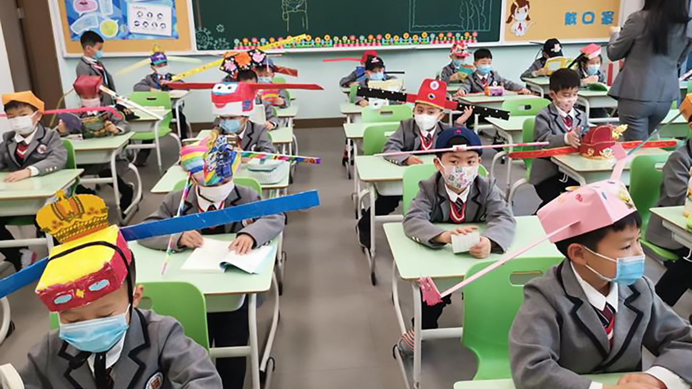 Kids in China Return To School With Home-made Social Distancing Hats